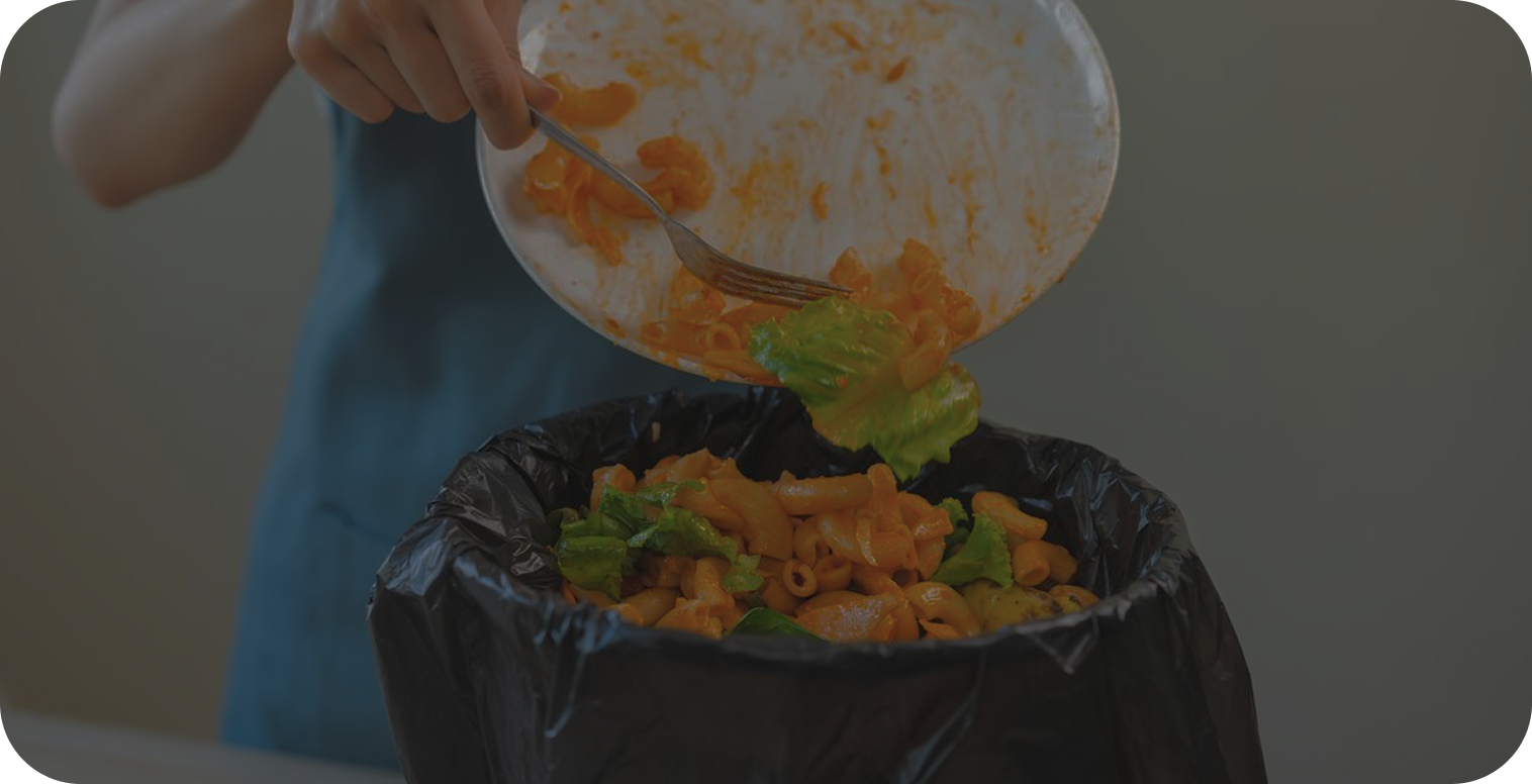 Food being scraped into a bin